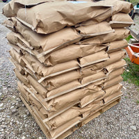 A full pallet of bags of organic feed from Far Out Feeds